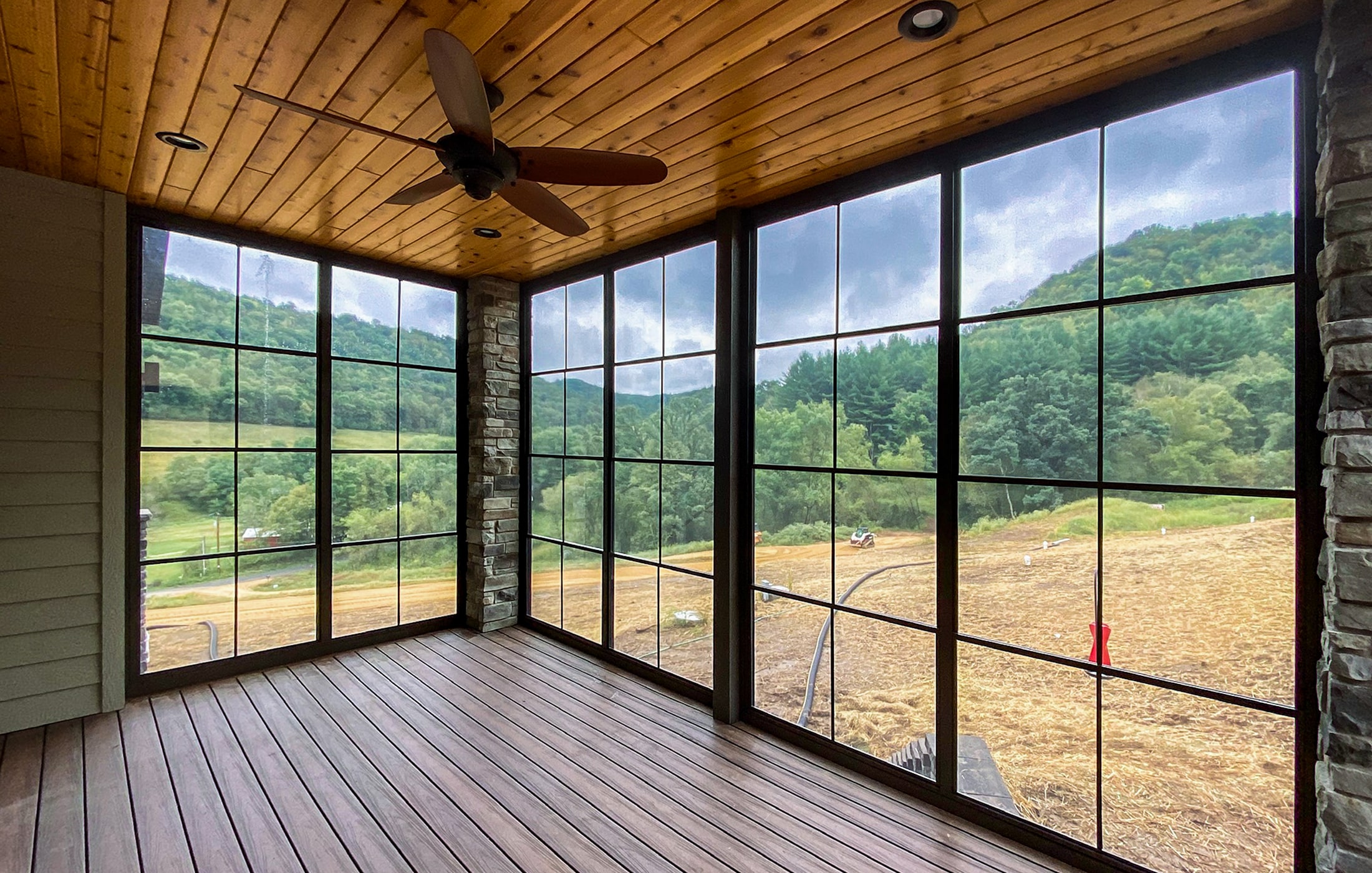 Sunspace screen room with retractable power screens and black window frames