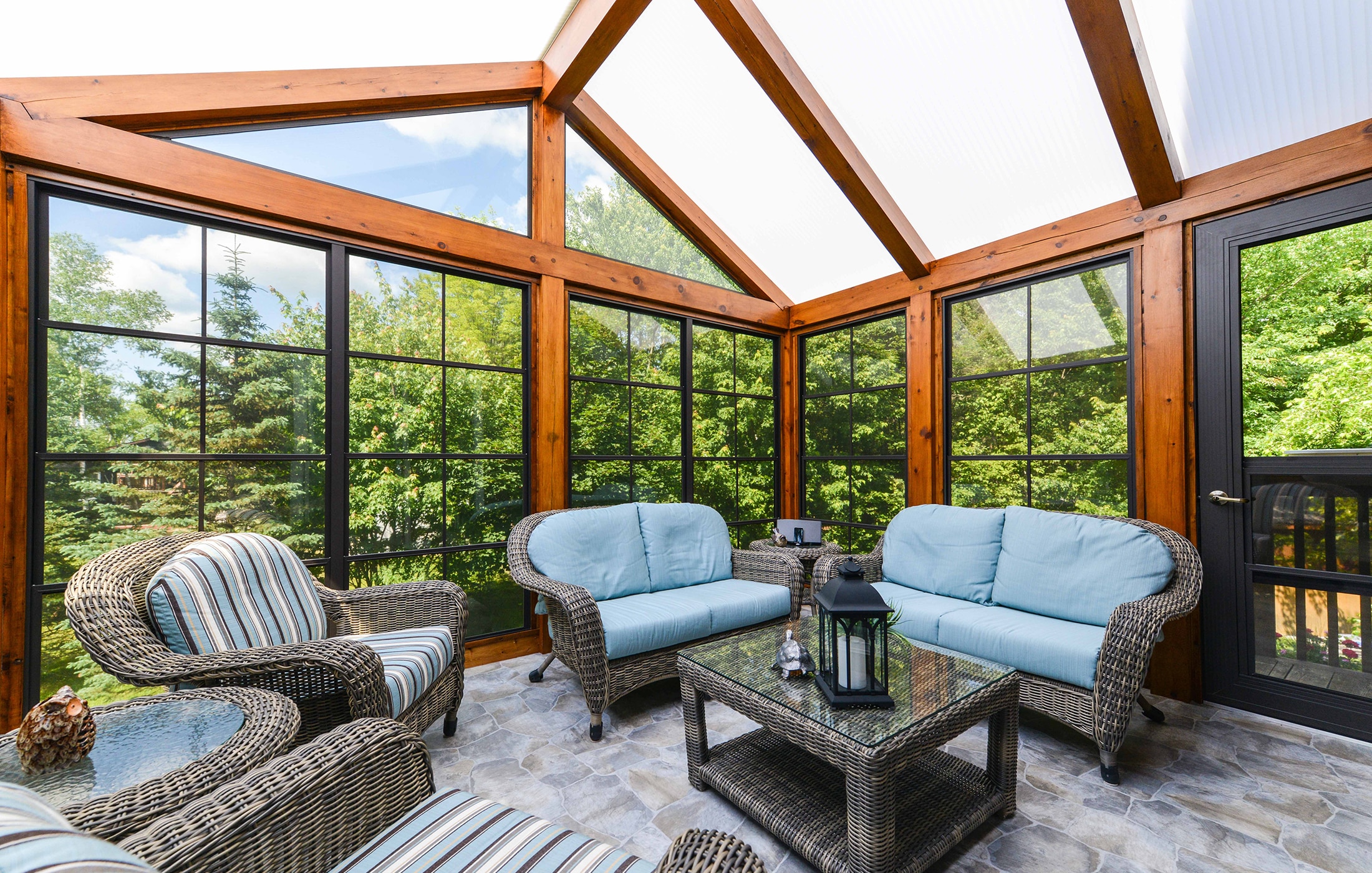Custom sunroom with cedar beams and acrylic roof built by Trenkle Construction