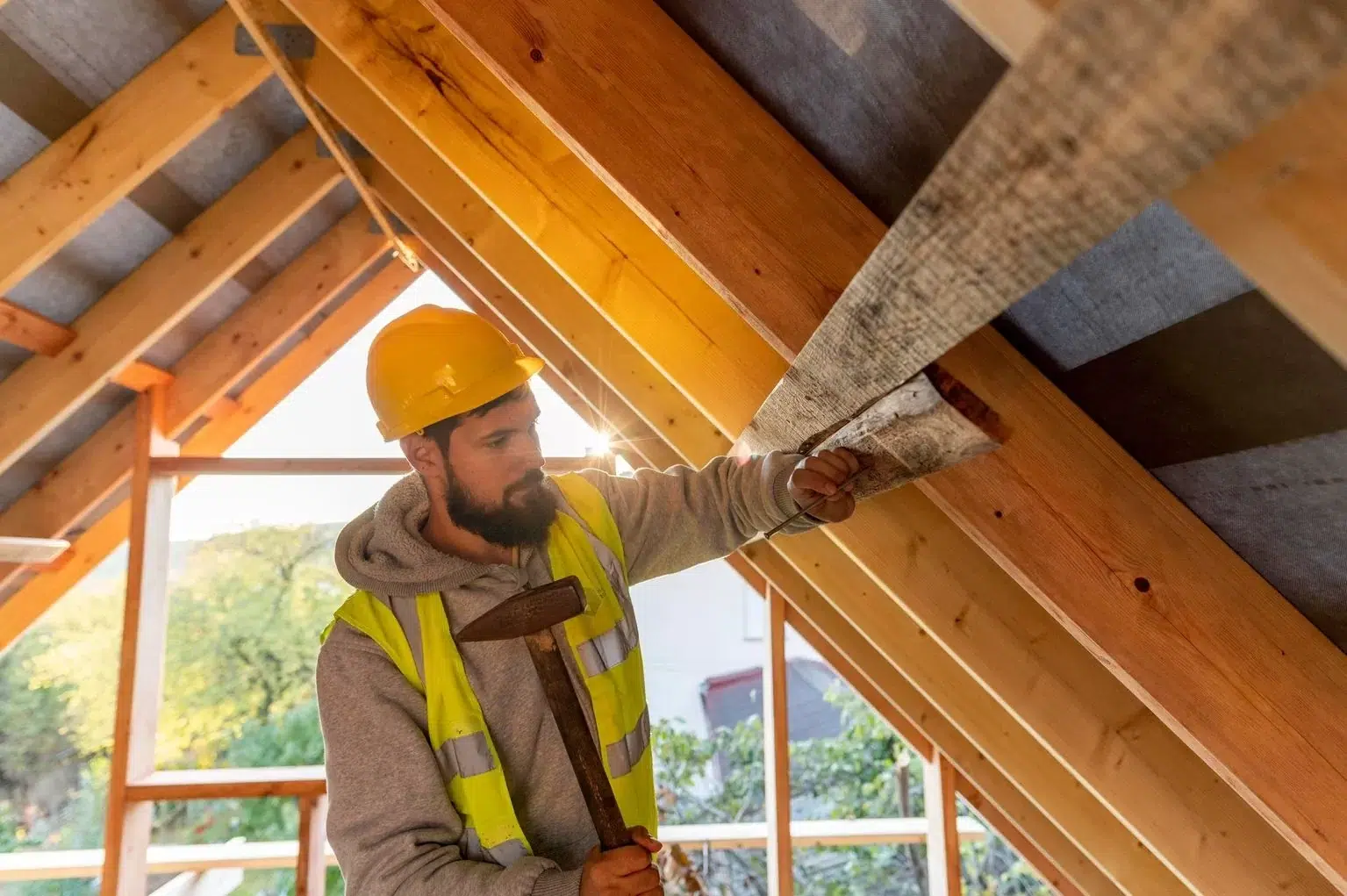 Trenkle Construction carpenter framing a new roof structure